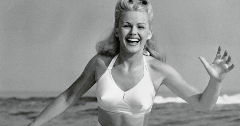 lady smiling running at the beach