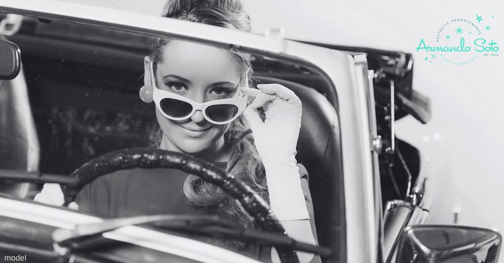 woman in convertible car in 1950s clothing (model)